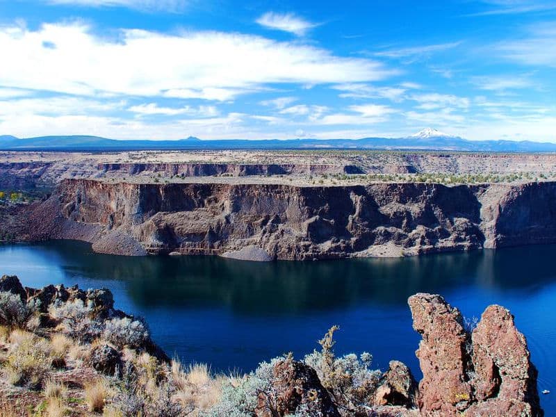 The blue water is a striking contrast to the almost barren land Photos