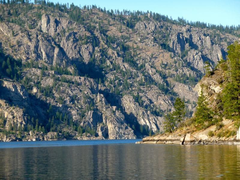 Float by sharp, rocky vistas dotted with trees Photos