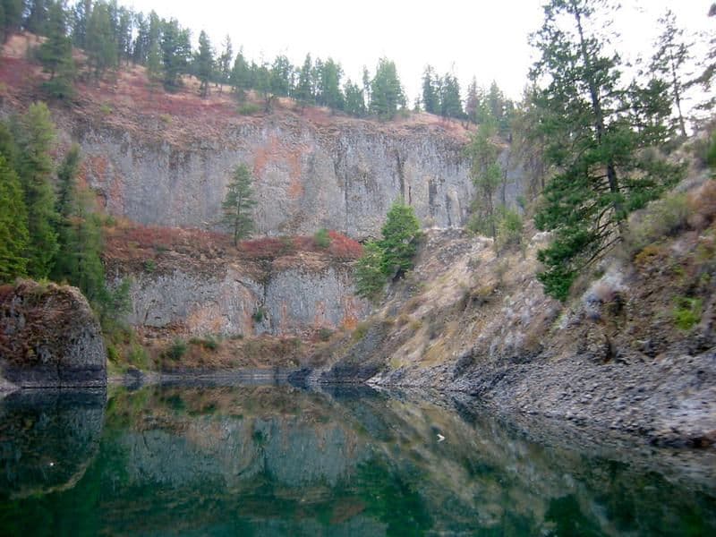 Colorful rock formations tower over the water Photos