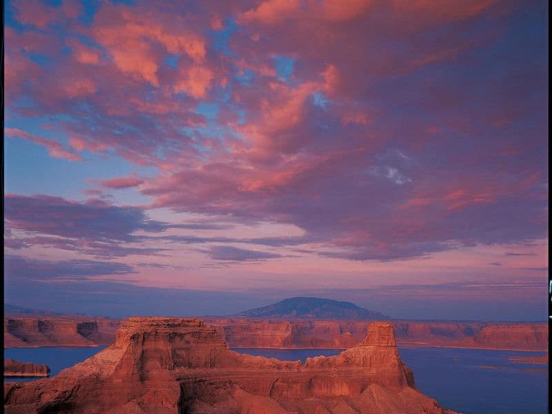 Deep blue water contained within orange-red cliff walls Photos