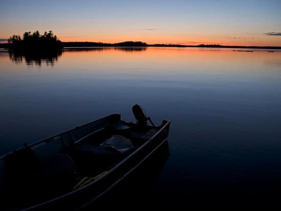 An almost faded sun over the glassy water