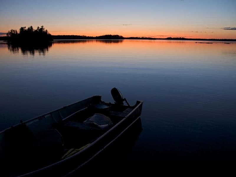 An almost faded sun over the glassy water Photos